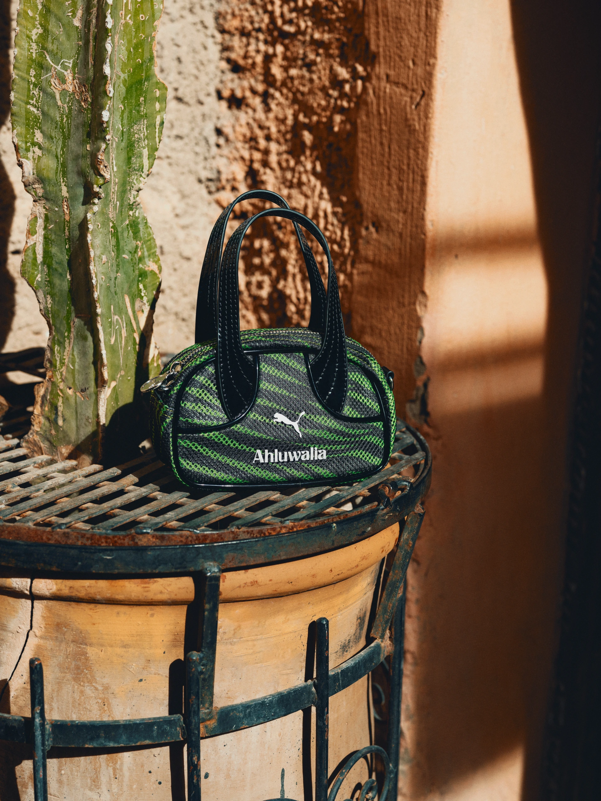 A small green and black bag resting on a chair