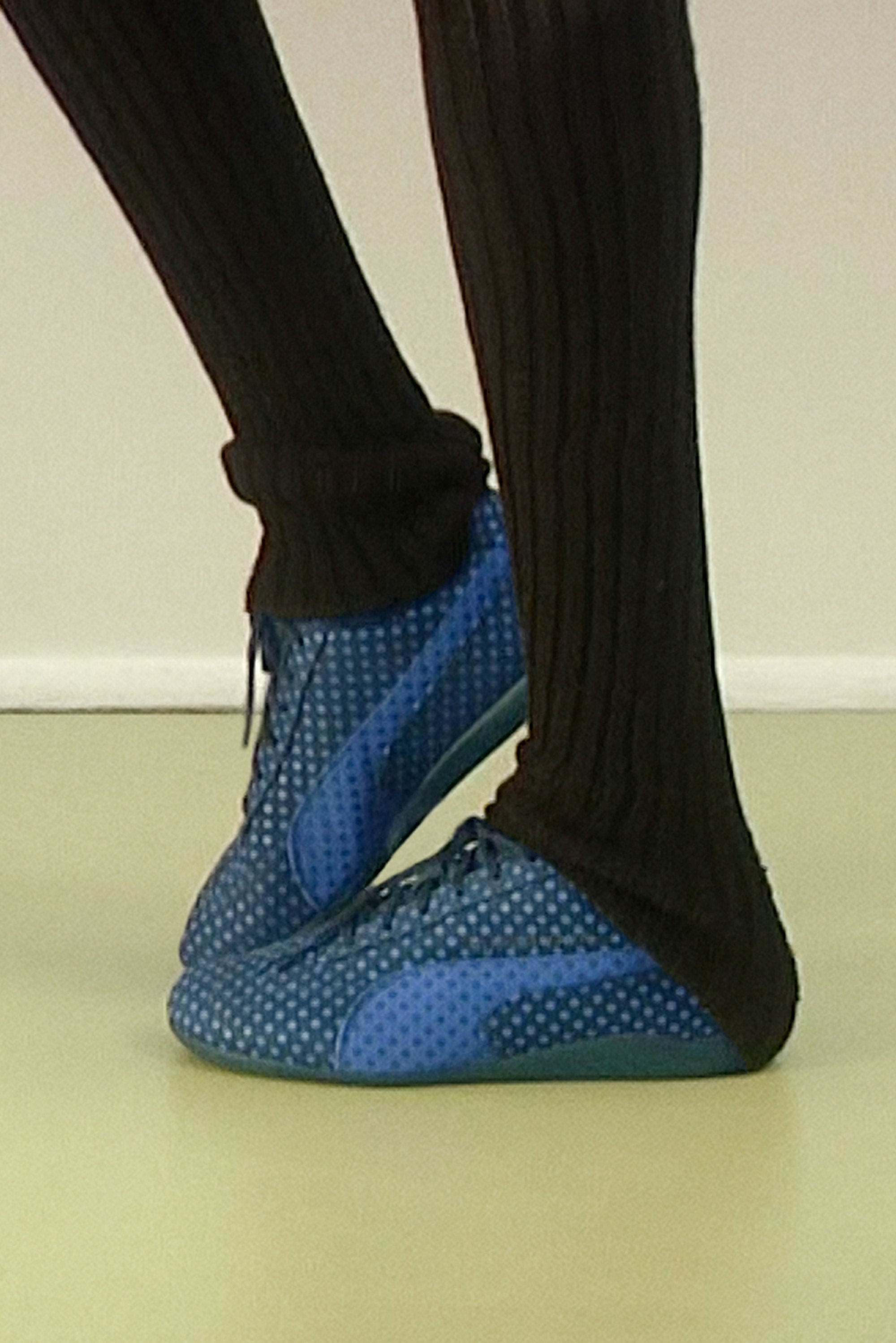 Blue polka-dot canvas shoes worn en pointe
