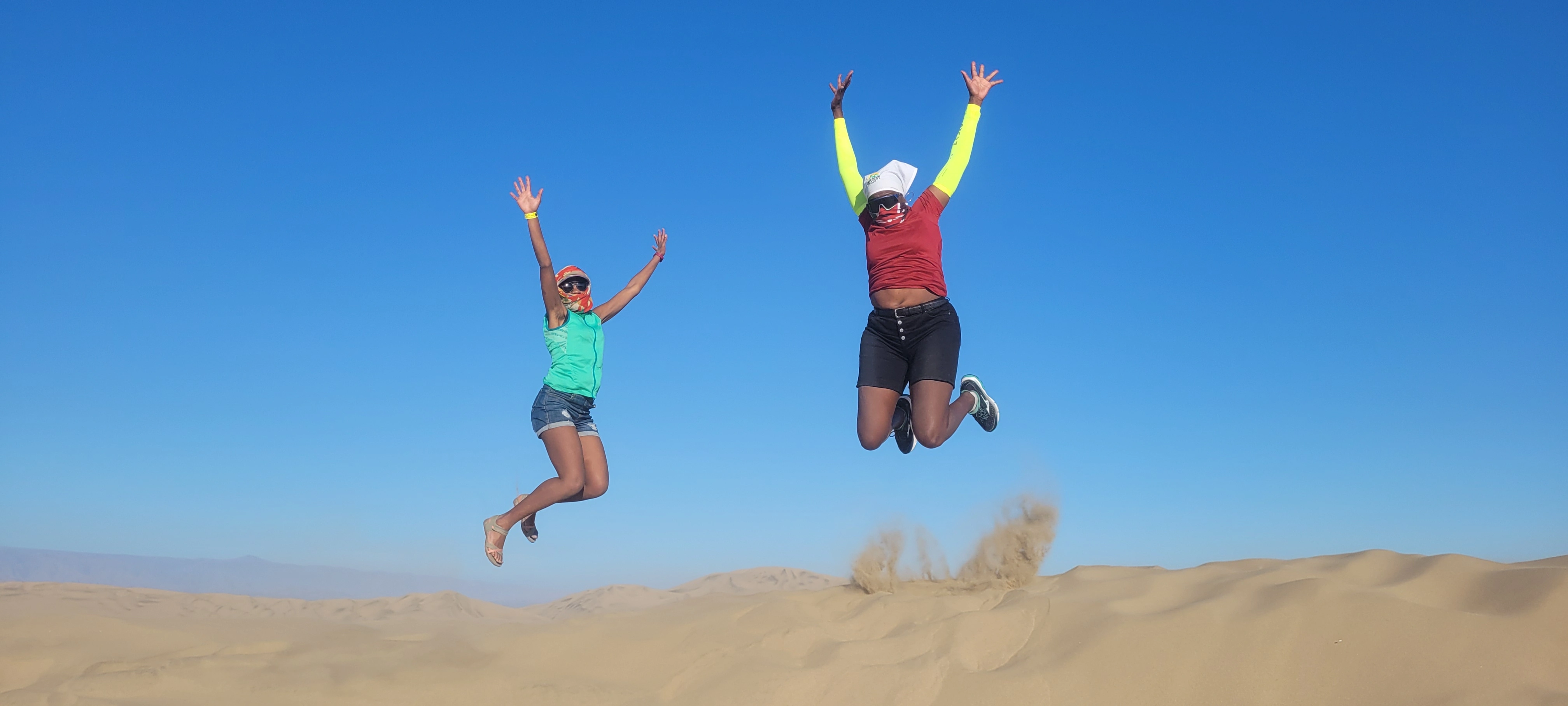 Two sportswomen jumping outdoors, photograph associated with Wandia Maina's profile by Mountain Slayers Kenya